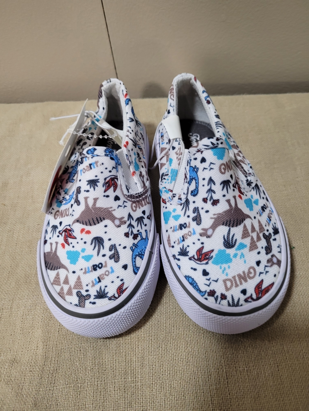 Tommy Bahama Kids White Canvas Slip-On Sneakers with Blue & Brown Dino Print